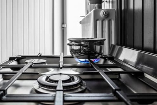 Built-in hob with blue flame and cooking equipment