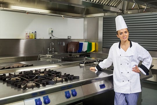 Commercial-Gas_img2 Chef standing in a professional kitchen with cooking equipment