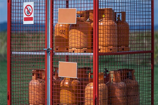 Secure cylinder storage enclosure for safety compliance of bottles with gas inside