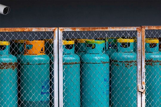 Padlocked cylinder storage enclosure for safety compliance